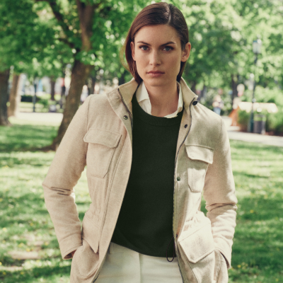 Woman wearing a beige jacket in a park setting